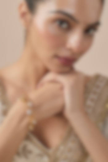 Gold Finish Kundan Polki Bangles (Set Of 2) by Vivinia By Vidhi Mehra at Pernia's Pop Up Shop