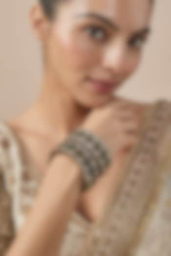 Gold Finish Kundan Polki & Green Stone Bangles (Set Of 2) by Vivinia By Vidhi Mehra at Pernia's Pop Up Shop