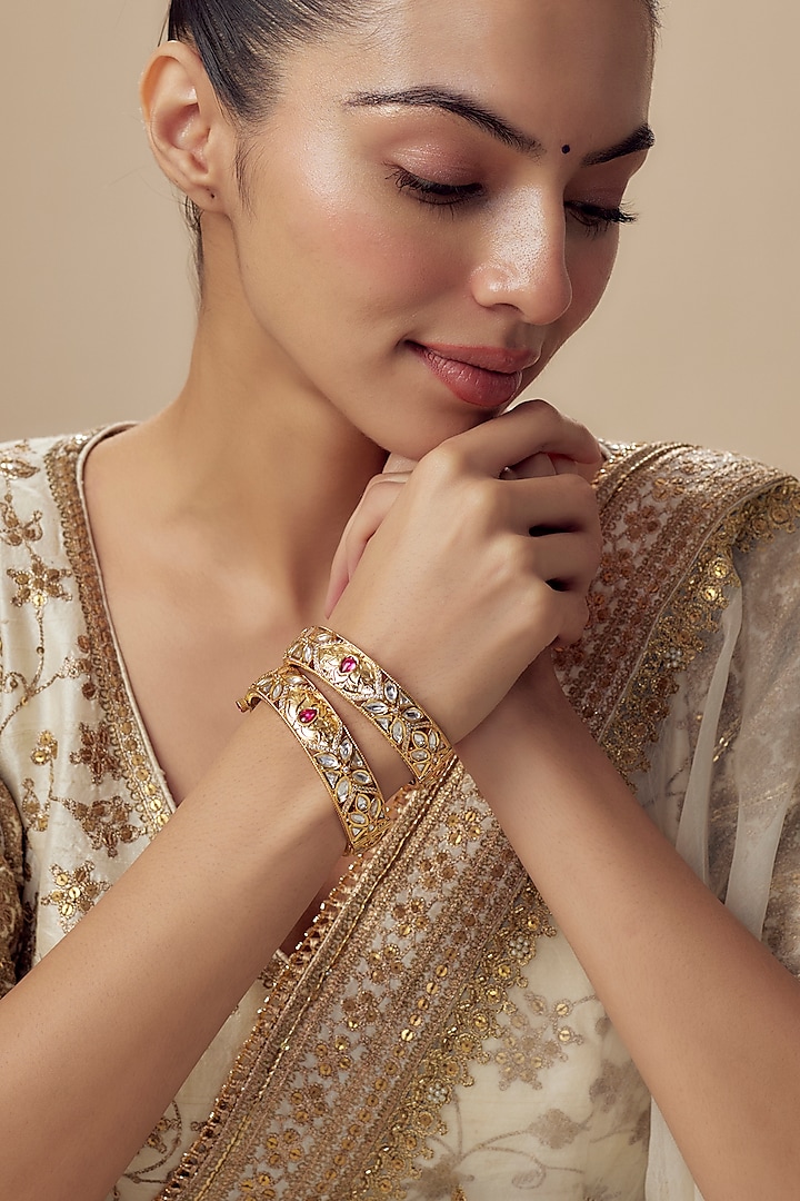 Gold Finish Kundan Polki Bangles (Set Of 2) by Vivinia By Vidhi Mehra at Pernia's Pop Up Shop