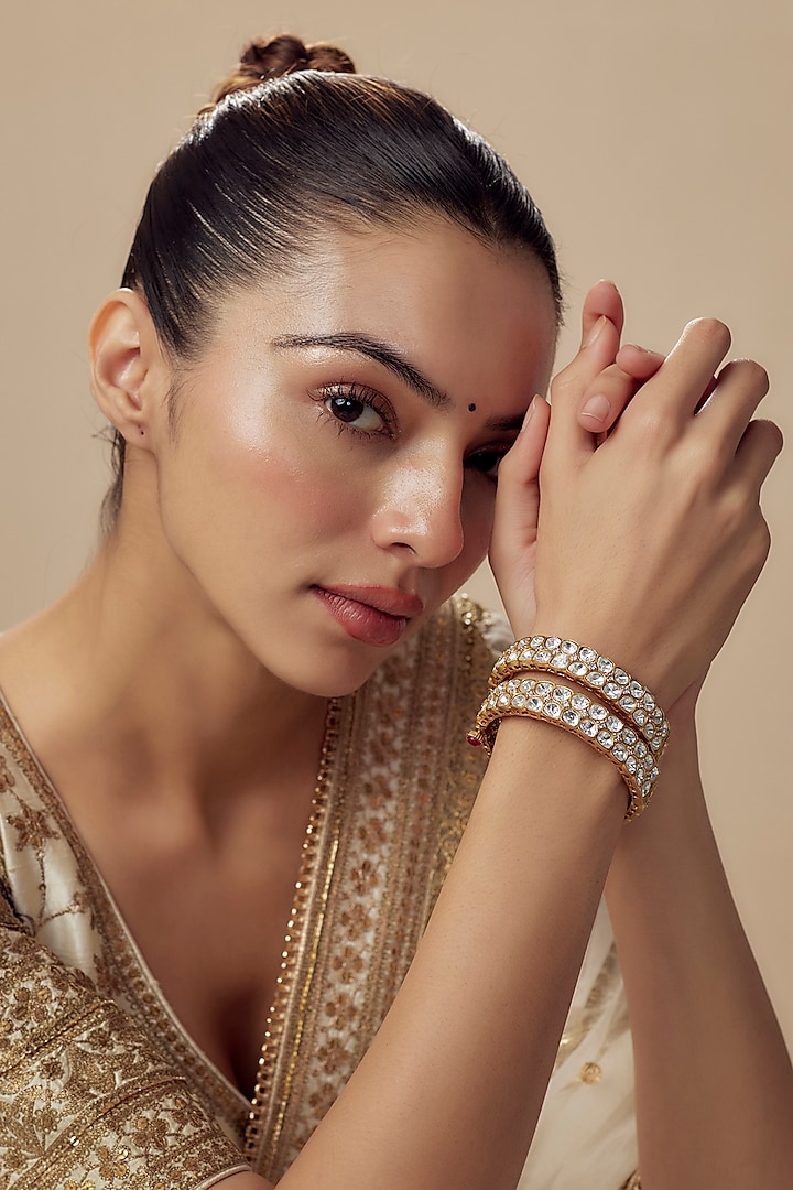 Gold Finish Kundan Polki Bangles (Set Of 2) by Vivinia By Vidhi Mehra at Pernia's Pop Up Shop