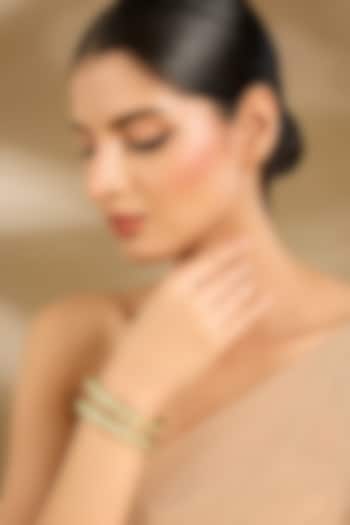 Gold Finish Pastel Green Stone Bangles (Set Of 2) by Vivinia By Vidhi Mehra at Pernia's Pop Up Shop