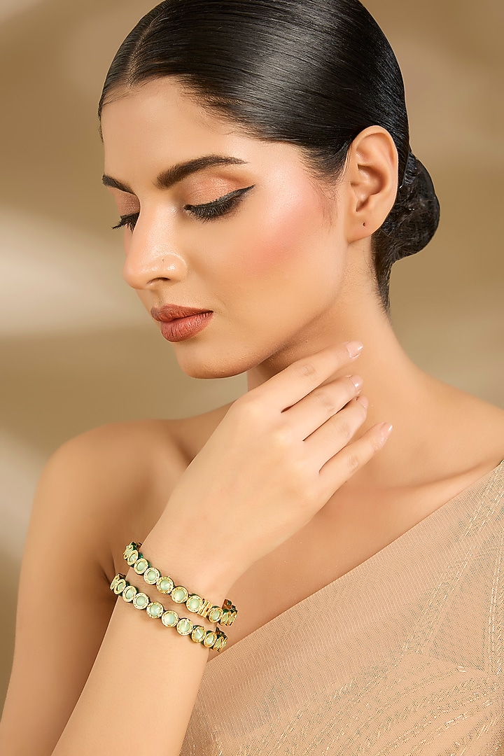 Gold Finish Pastel Green Stone Bangles (Set Of 2) by Vivinia By Vidhi Mehra at Pernia's Pop Up Shop