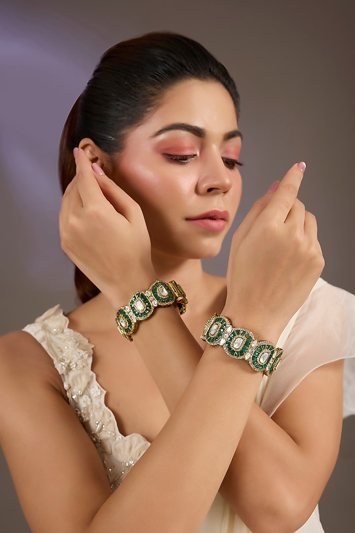 Gold Finish Kundan Polki & Green Stone Bangles (Set Of 2) by Vivinia By Vidhi Mehra at Pernia's Pop Up Shop