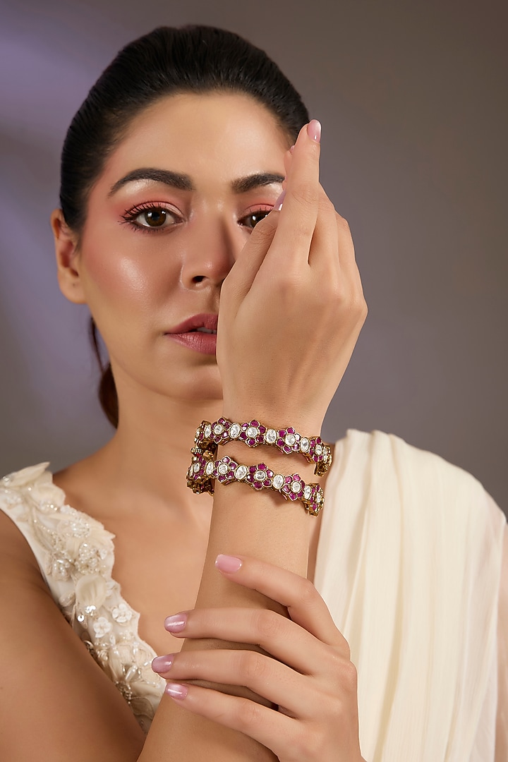 Gold Finish Ruby Kundan Polki Floral Bangles (Set Of 2) by Vivinia By Vidhi Mehra at Pernia's Pop Up Shop