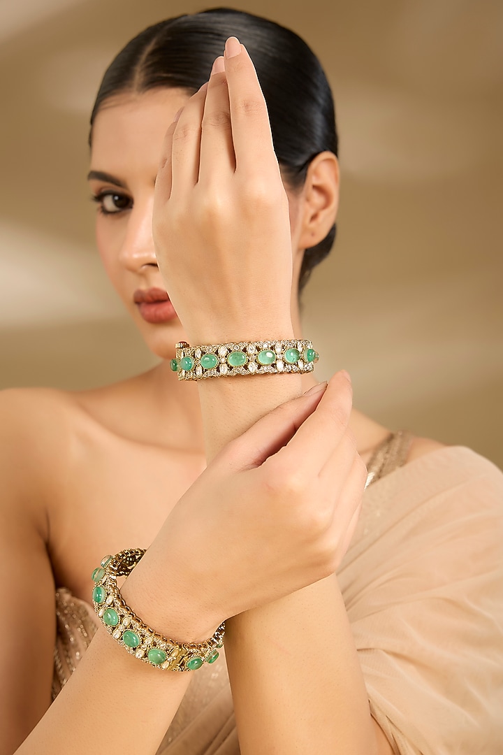Gold Finish Kundan Polki & Emerald Stone Bangles (Set Of 2) by Vivinia By Vidhi Mehra at Pernia's Pop Up Shop