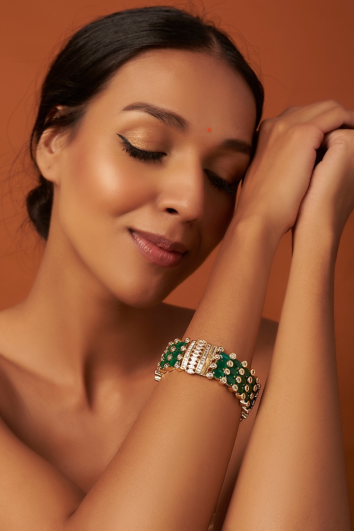 Gold Finish Emerald Synthetic Stones Bangle by Vivinia By Vidhi Mehra