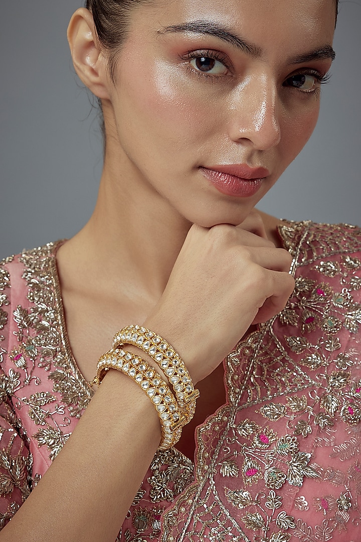 Gold Finish Kundan Polki Bangles (Set Of 2) by Vivinia By Vidhi Mehra at Pernia's Pop Up Shop