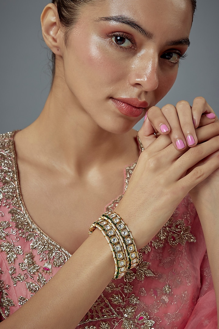 Gold Finish Kundan Polki Bangles (Set Of 2) by Vivinia By Vidhi Mehra at Pernia's Pop Up Shop