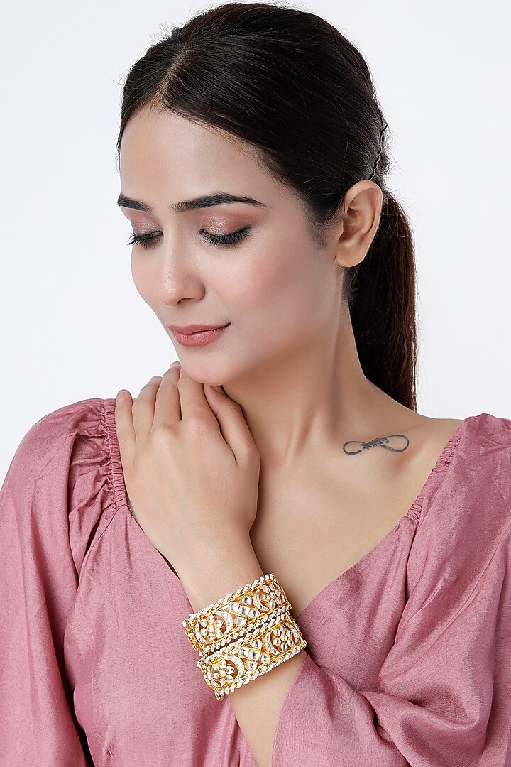 Gold Finish Kundan Polki & Pearl Bangles (Set of 2) by Vivinia By Vidhi Mehra at Pernia's Pop Up Shop