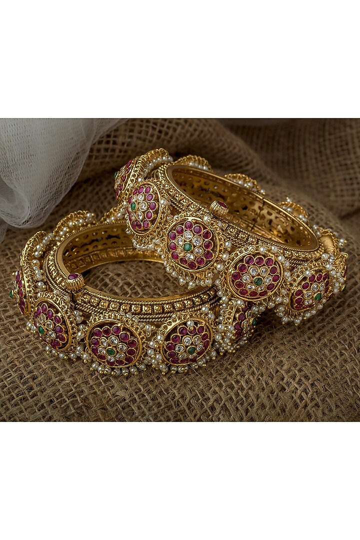 Gold Finish Kundan Polki Bangles (Set Of 2) by Vivinia By Vidhi Mehra at Pernia's Pop Up Shop