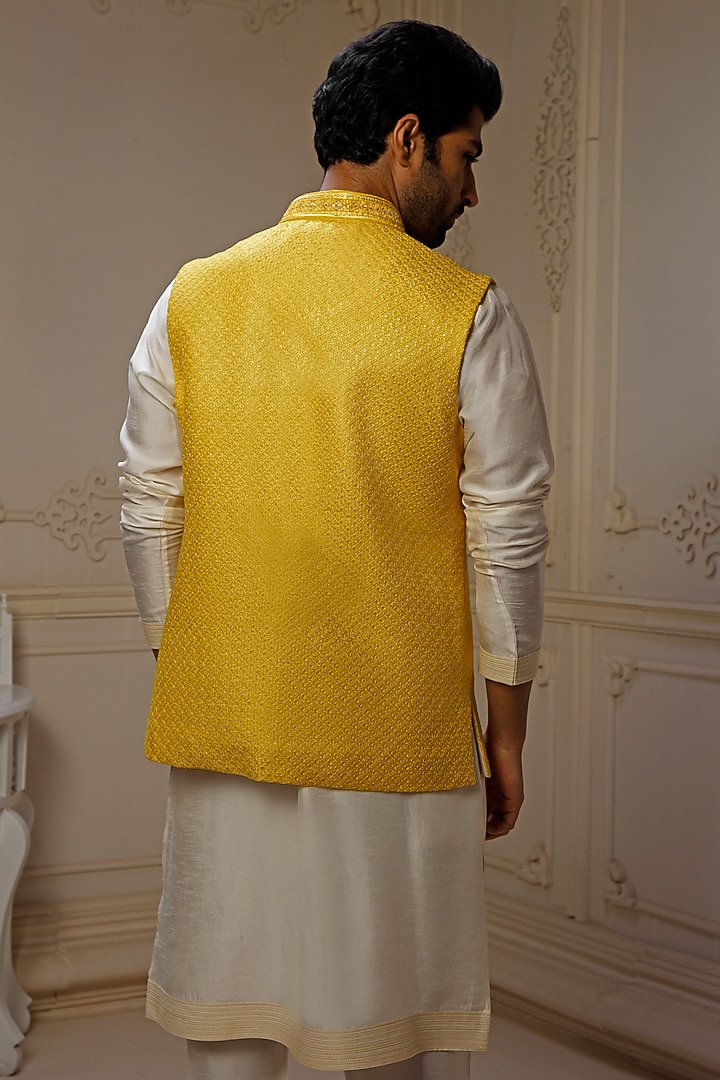 Yellow Dupion Silk Self Embroidered Bundi Jacket Set by Vanshik at Pernia's Pop Up Shop