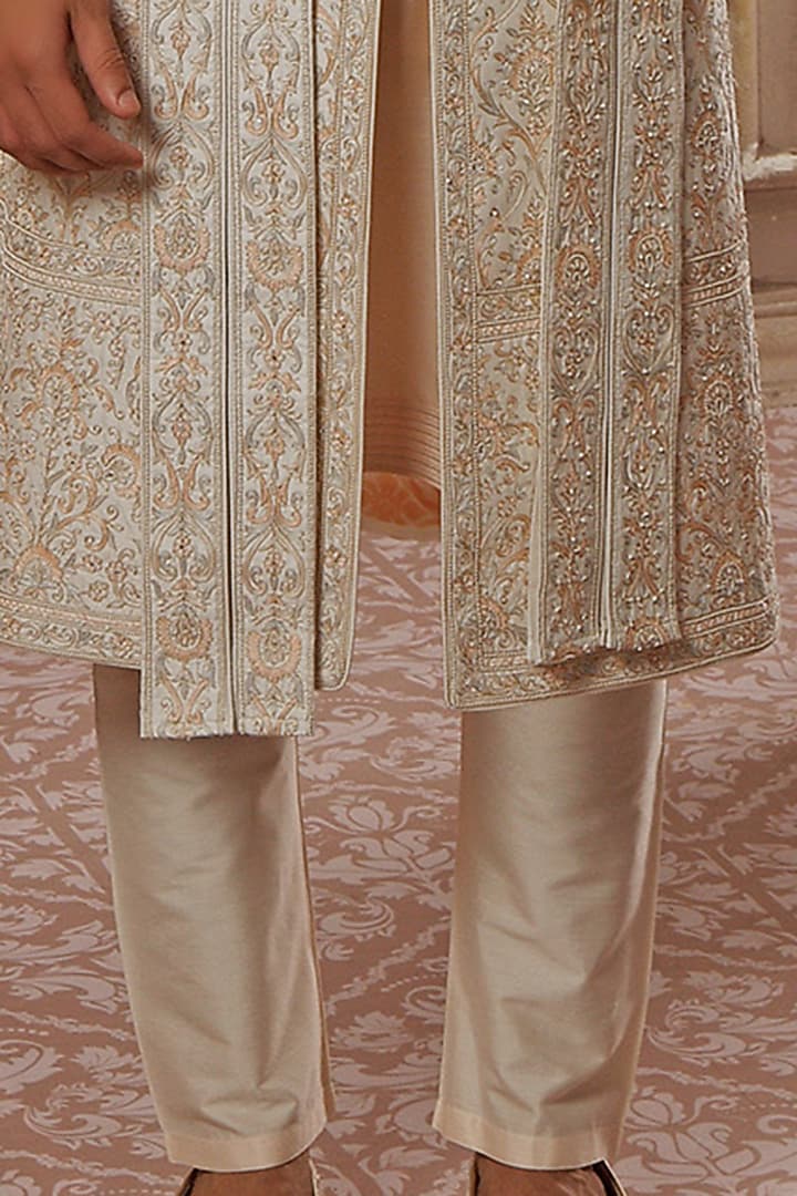 Cream Raw Silk Aari Hand Embroidered Groom Sherwani Set by Vanshik at Pernia's Pop Up Shop