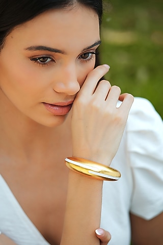 Gold Plated White Enameled Circlet Bangle by Varnika Arora