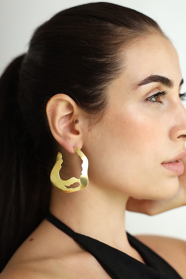 Gold Finish Abstract Wave Stud Earrings by Varnika Arora at Pernia's Pop Up Shop