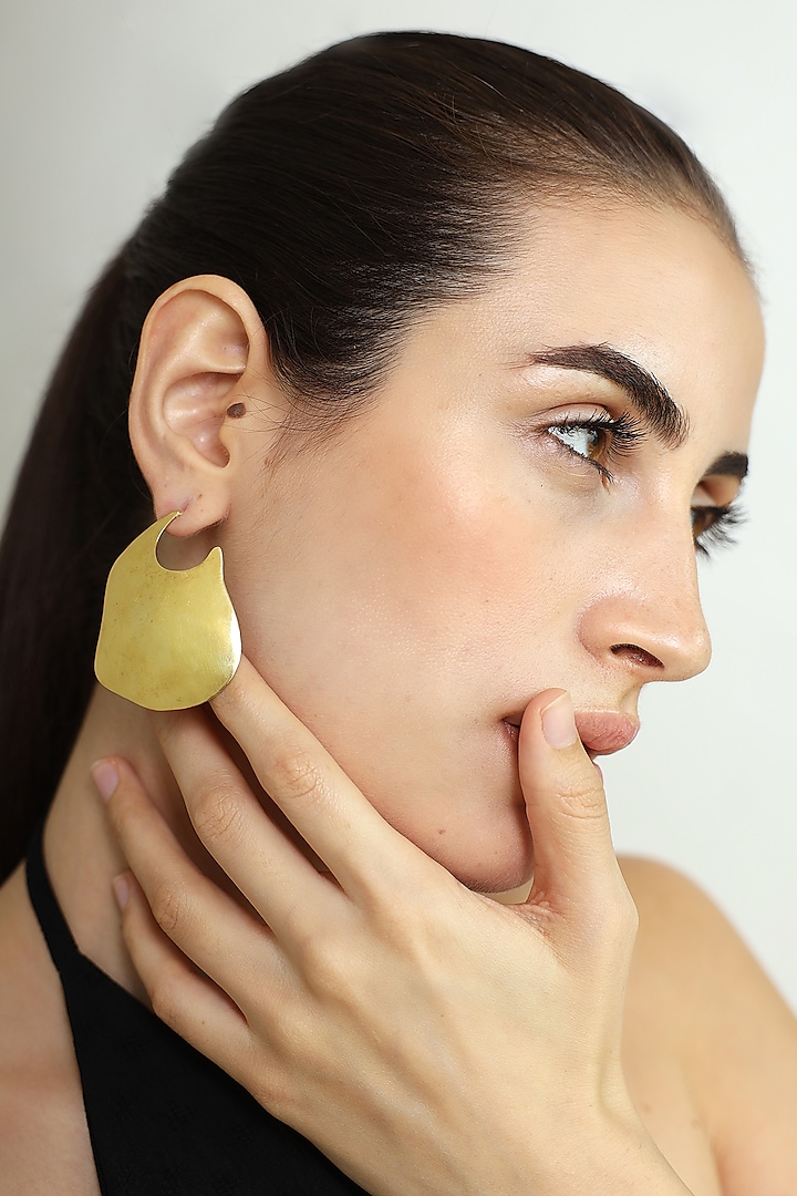 Gold Finish Curved Stud Earrings by Varnika Arora at Pernia's Pop Up Shop