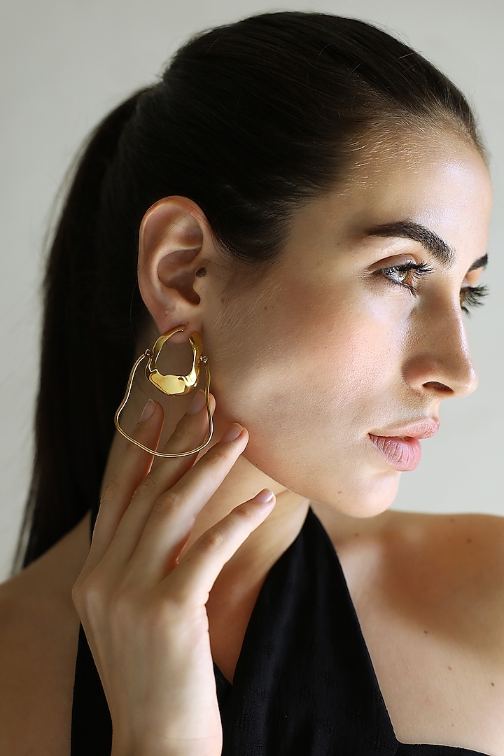 Gold Finish Irregular Hoop Earrings by Varnika Arora at Pernia's Pop Up Shop