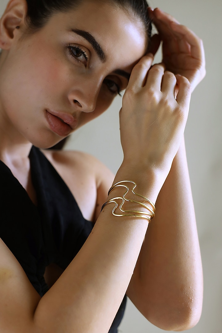 Gold Finish Fluid Bangles (Set Of 4) by Varnika Arora at Pernia's Pop Up Shop