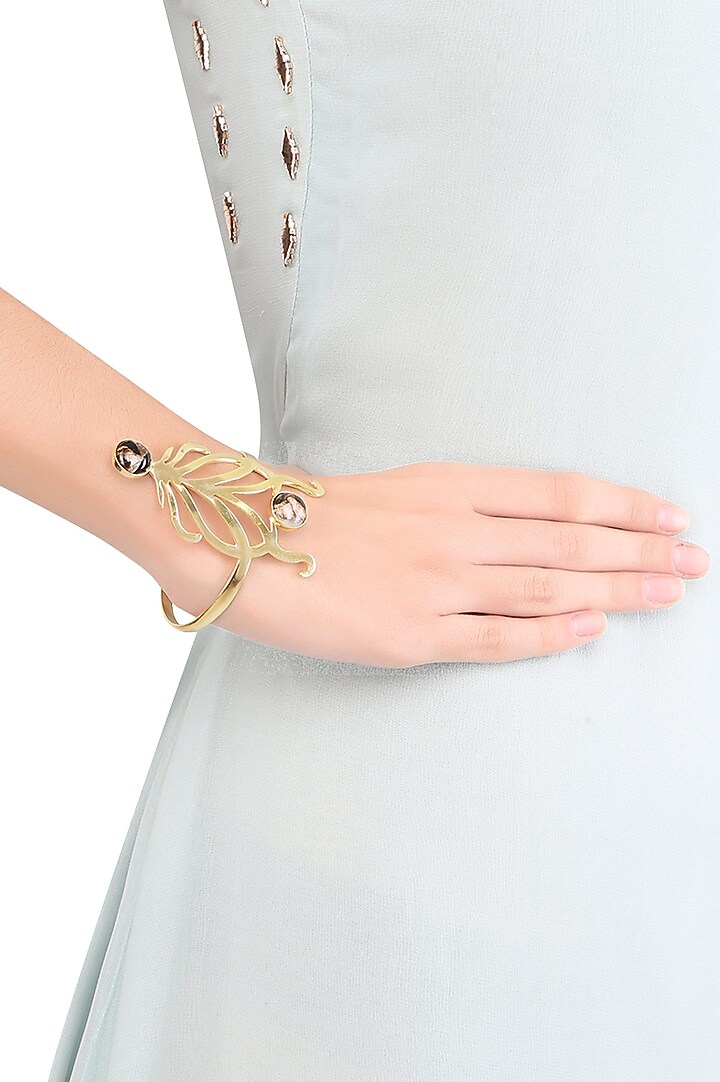 Varnika Arora presents Gold plated cabochon mohave copper mix stone statement wrist palmcuff available only at Pernia's Pop Up Shop.