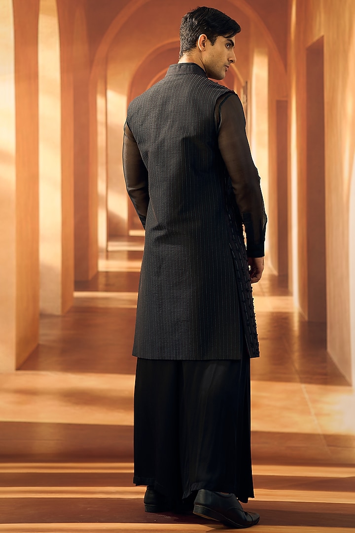 Black Semi Raw Silk Machine Embroidered Sleeveless Open Wedding Sherwani by Vivek Karunakaran at Pernia's Pop Up Shop