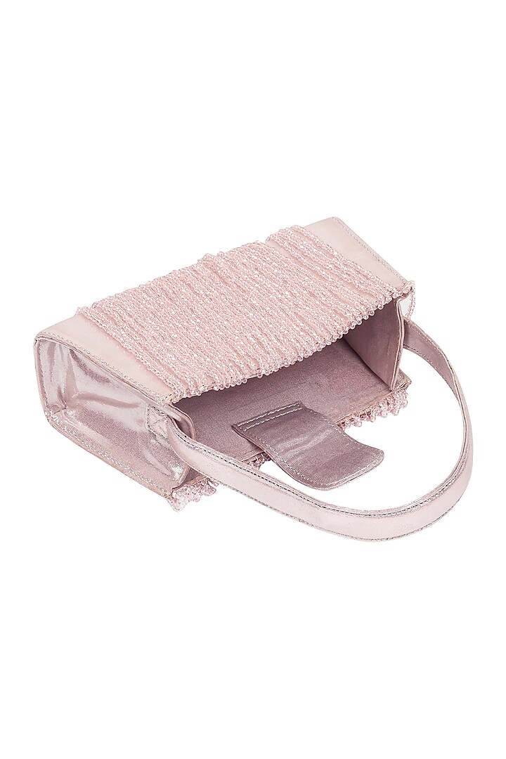 Pink Foiled Fabric Tasseled Hand Bag by X FEET ABOVE at Pernia's Pop Up Shop