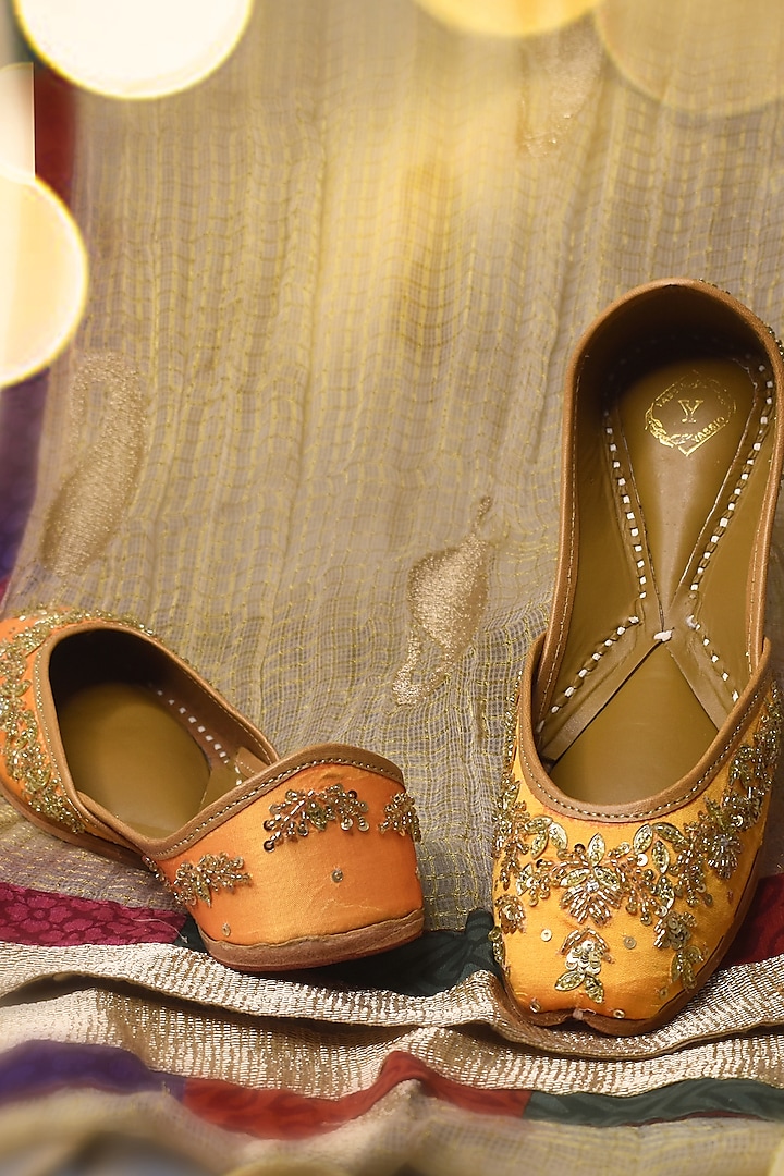 Yellow Raw Silk Cutdana & Sequins Embroidered Juttis by YASSIO at Pernia's Pop Up Shop