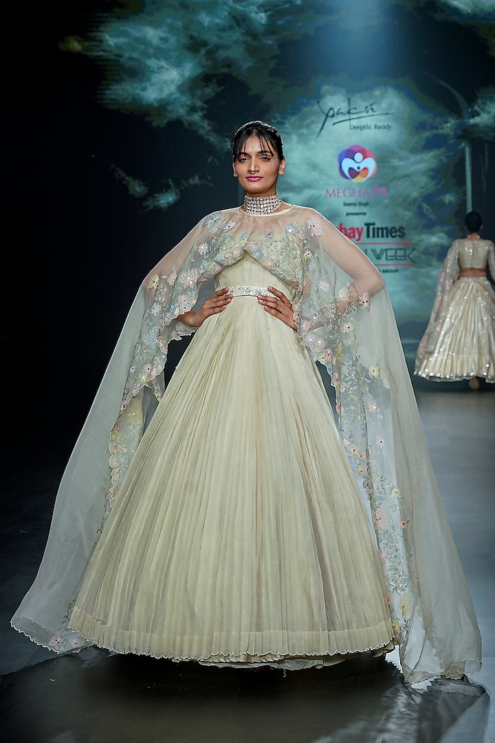 Light Yellow Organza Pleated Gown With Cape by Yaksi Deepthi Reddy