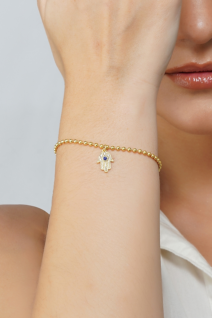 Gold Plated Cubic Zircon & Lapis Lazuli Hamsa Hand Bracelet by Zariin at Pernia's Pop Up Shop