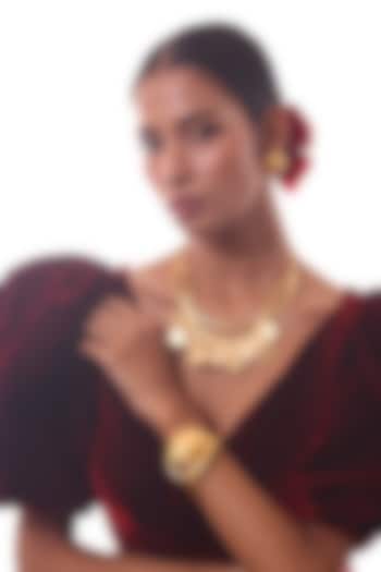 Gold Finish Round Ornate Bracelet by ZAZA BY SOMYA at Pernia's Pop Up Shop