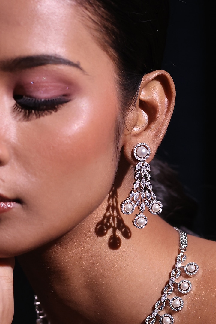 White Finish Pearl & Zircon Dangler Earrings by ZAZA BY SOMYA at Pernia's Pop Up Shop
