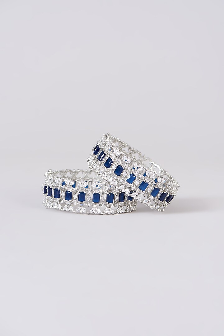 White Finish Faux Diamond & Sapphire Stone Bangles (Set of 2) by Zevar By Geeta at Pernia's Pop Up Shop