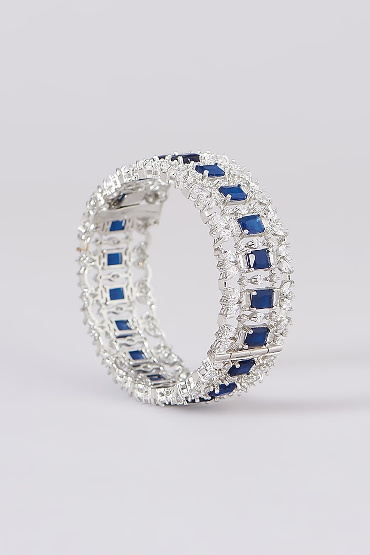 White Finish Faux Diamond & Sapphire Stone Bangles (Set of 2) by Zevar By Geeta at Pernia's Pop Up Shop