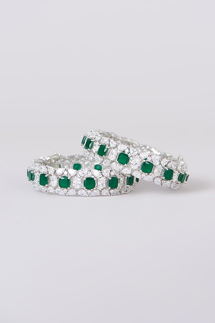 White Finish Faux Diamond & Emerald Stone Bangles (Set of 2) by Zevar By Geeta at Pernia's Pop Up Shop
