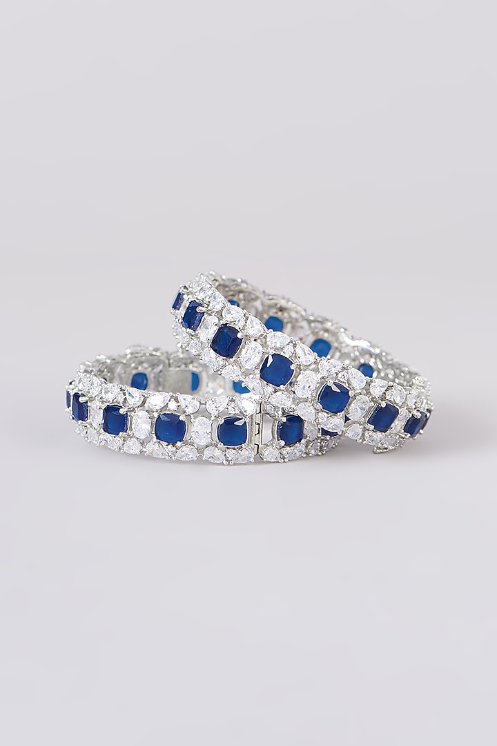White Finish Faux Diamond & Sapphire Stone Bangles (Set of 2) by Zevar By Geeta at Pernia's Pop Up Shop