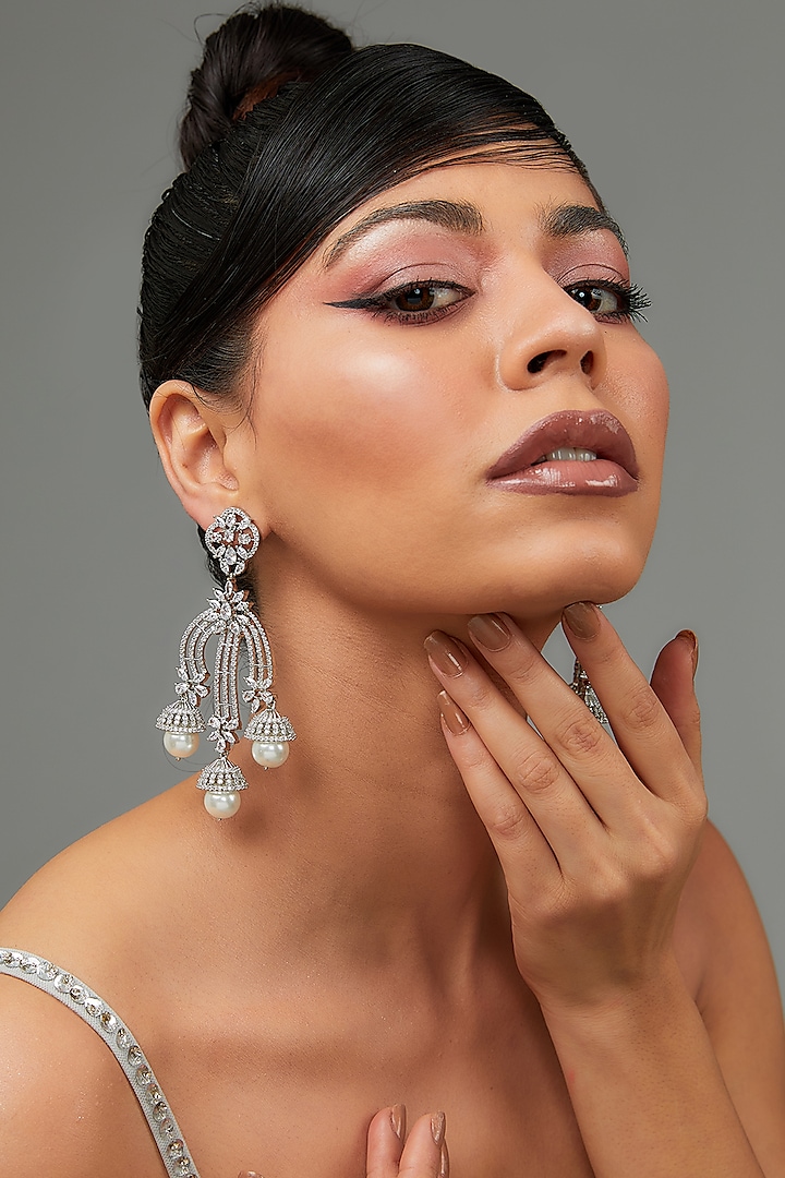 White Finish Faux Diamond Dangler Earrings by Zevar By Geeta