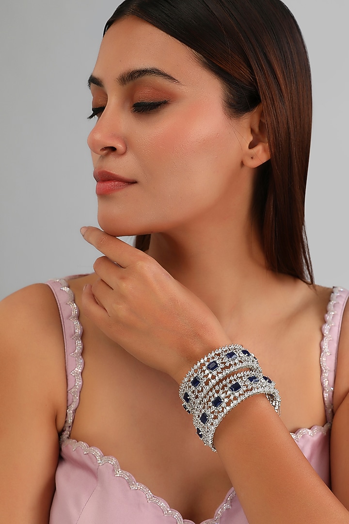 White Finish Diamond & Sapphire Stone Bangles (Set of 2) by Zevar By Geeta at Pernia's Pop Up Shop