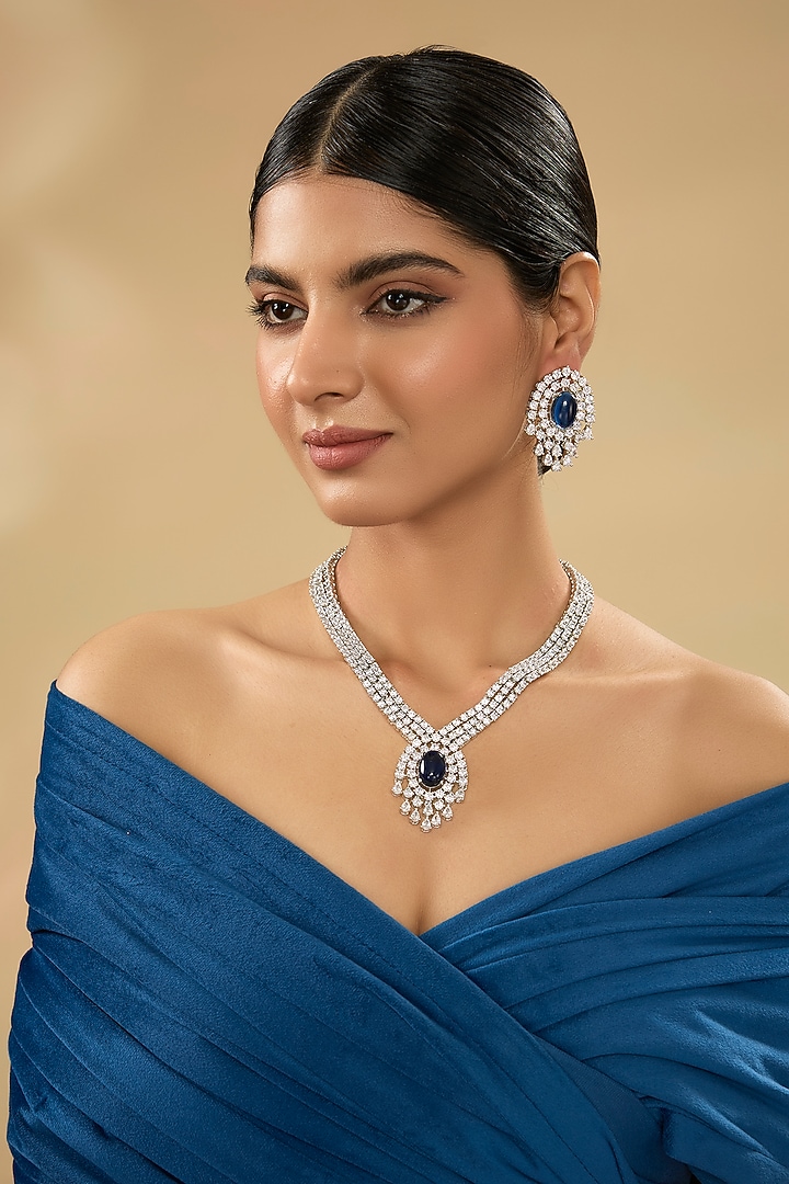 White Finish Diamond & Blue Stone Pendant Necklace Set by Zevar By Geeta at Pernia's Pop Up Shop