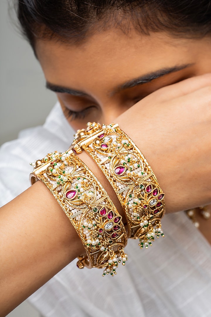 Gold Finish Kundan Polki & Red Stone Kadas (Set Of 2) by Zevar King at Pernia's Pop Up Shop